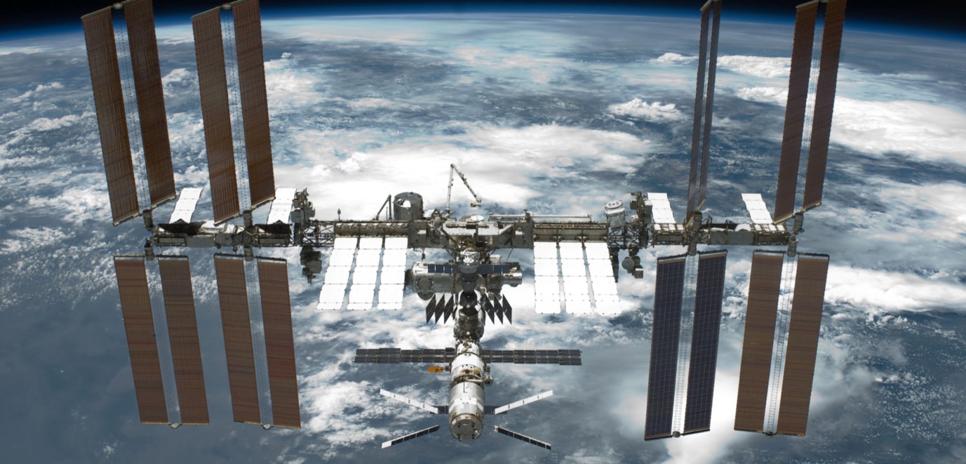 Picture of the International Space Station with the Alpha Magnetic Spectrometer installed on its main truss (right side) taken from Space Shuttle Endeavour Mission STS-134 in its way back to ground.