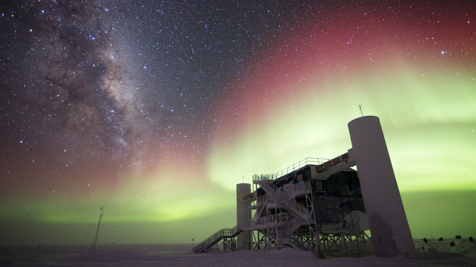 A colorful aurora swirling above the IceCube Lab. Credit: Keith Vanderlinde